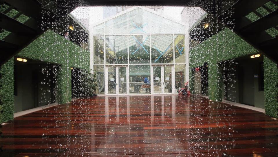 A waterfall cascades in an outdoor space at THE OUT NYC in midtown Manhattan. THE OUT NYC, designed by Paul Dominguez, features spaces to be used as a business and conference center or for intimate private diners, large events and weddings.