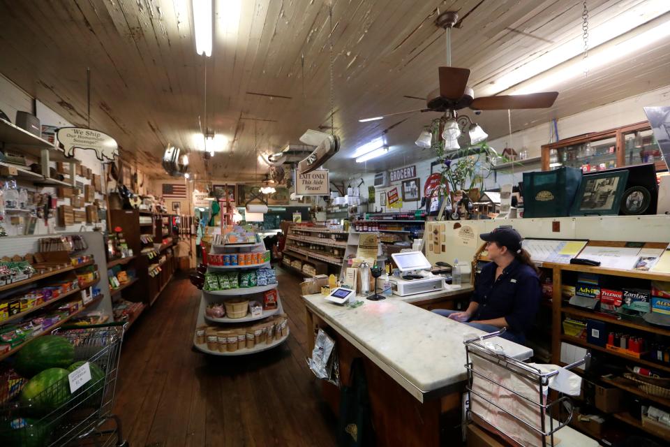 Cashier at Bradley's Country Store, E.G. Jones, patiently awaits a customer to bring up their meat order to purchase at Bradley's Country Store. 
