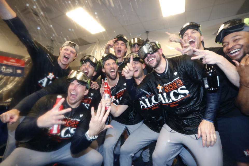 The Houston Astros celebrate in the locker room after the team defeated the Minnesota Twins in Game 4 to win a baseball AL Division Series, Wednesday, Oct. 11, 2023, in Minneapolis. (AP Photo/Bruce Kluckhohn)