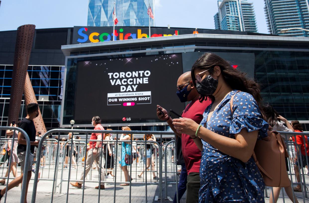 People line up to enter a mass vaccination site in Toronto in June.