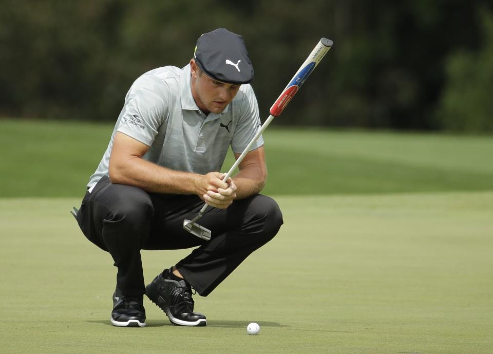 Bryson DeChambeau looks over his putt on the third hole during the second round for the Masters golf tournament Friday, April 12, 2019, in Augusta, Ga. (AP Photo/Charlie Riedel)