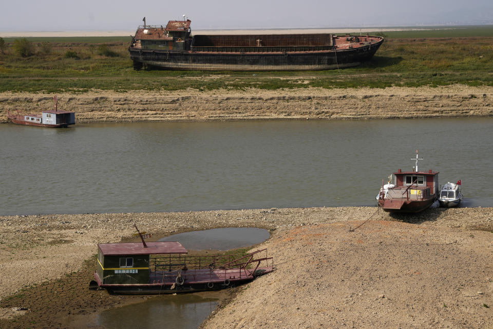 Boats are stranded as water levels plunge around Poyang Lake during drought season in north-central China's Jiangxi province on Tuesday, Nov. 1, 2022. A prolonged drought since July has dramatically shrunk China’s biggest freshwater lake, Poyang. (AP Photo/Ng Han Guan)