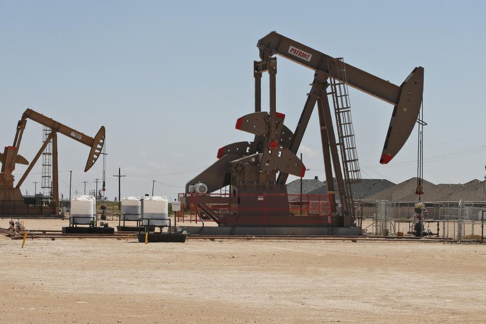 In this Monday, Sept. 2, 2019, photo, pump jacks stand next to a housing development in Odessa, Texas. Odessa, in the Permian Basin region, is known for its oil fields that cut into neighborhoods where a boom cycle has made housing expensive and scarce. (AP Photo/Sue Ogrocki)