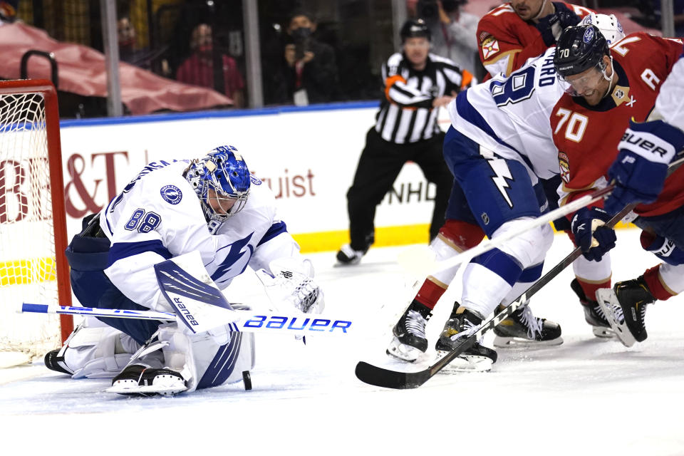 Tampa Bay Lightning goaltender Andrei Vasilevskiy (88) goes against Florida Panthers right wing Patric Hornqvist (70) as he stops a shot on the goal during the second period in Game 5 of an NHL hockey Stanley Cup first-round playoff series, Monday, May 24, 2021, in Sunrise, Fla. (AP Photo/Lynne Sladky)