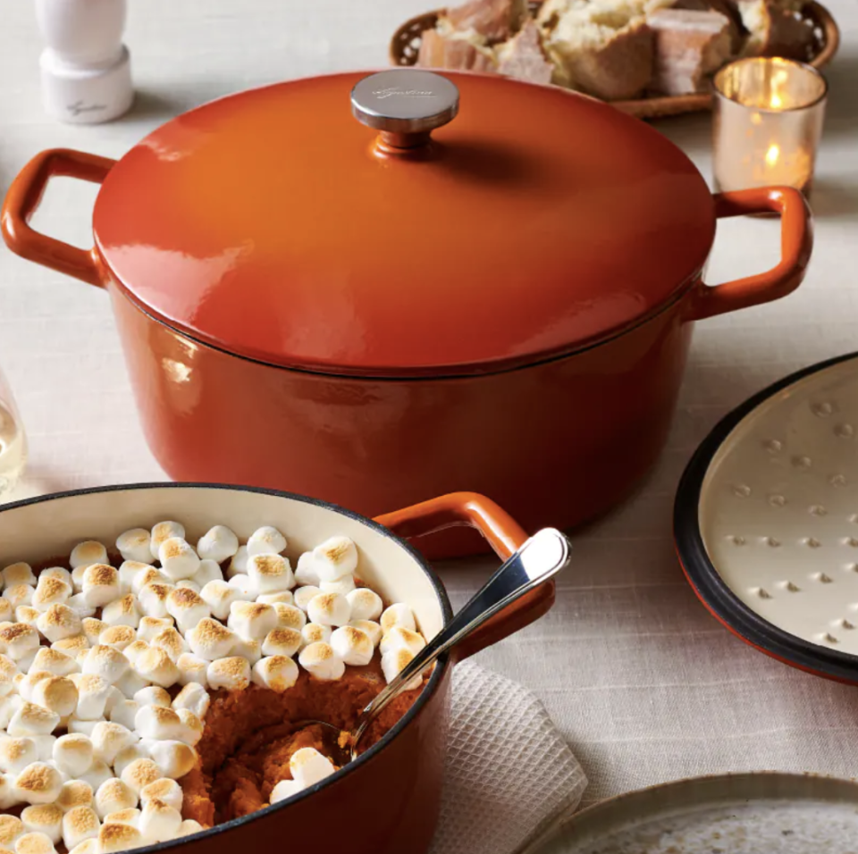 Lagostina Tuscan Collection Round Casserole Dish in orange on table (photo via Canadian Tire)