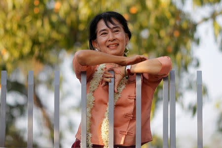 FILE PHOTO: Myanmar's pro-democracy leader Aung San Suu Kyi smiles at supporters as she celebrates Thingyan, Myanmar's new year water festival, in front of her home in Yangon April 16, 2012. REUTERS/Soe Zeya Tun/File Photo