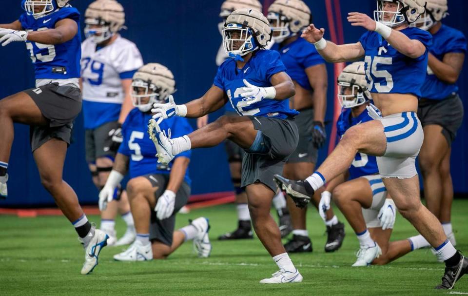 Duke linebackers Tre Freeman (12) and Cam Dillon (35) run through a drills with his teammates during the Blue Devils’ spring practice on Friday, March 24, 2023 in Durham, N.C.