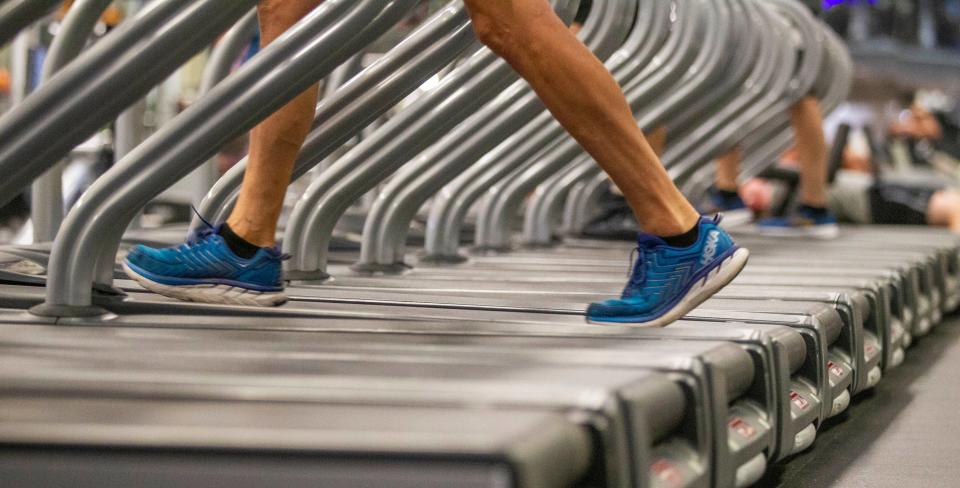 A man walks on a treadmill at Momentum Fitness.