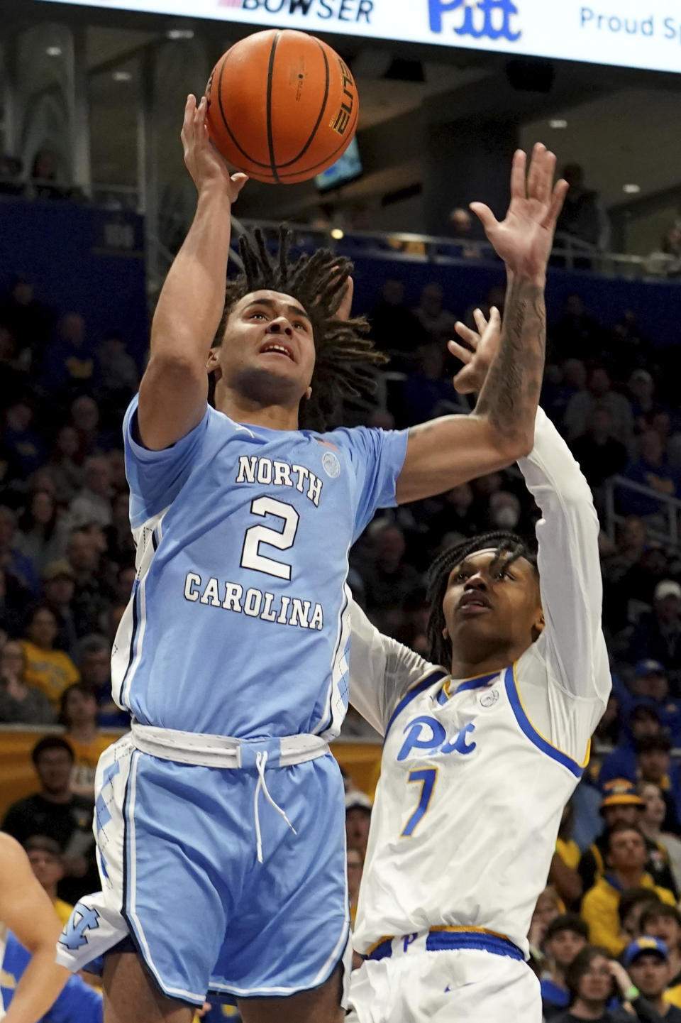 North Carolina guard Elliot Cadeau (2) shoots over Pittsburgh guard Carlton Carrington (7) during the first half of an NCAA college basketball game Tuesday, Jan. 2, 2024, in Pittsburgh. (AP Photo/Matt Freed)