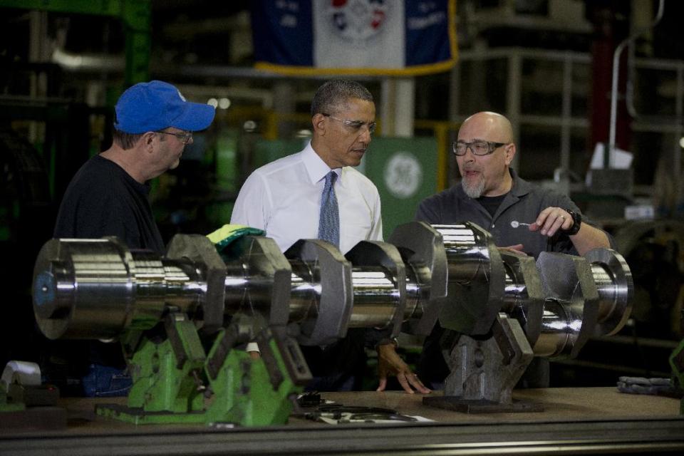 President Barack Obama looks at a crank shaft as he tours General Electric’s Waukesha Gas Engines facility, Thursday, Jan. 30, 2014, in Waukesha, Wis. as part of a four-stop tour he is making to expand on themes from his State of the Union address. (AP Photo)