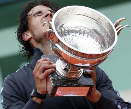 Spain's Rafael Nadal celebrates with his trophy after winning the French Open in Paris on June 11. Nadal clinched a record seventh French Open title on Monday, defeating world number one Novak Djokovic 6-4, 6-3, 2-6, 7-5 and shattering the Serb's dream of Grand Slam history