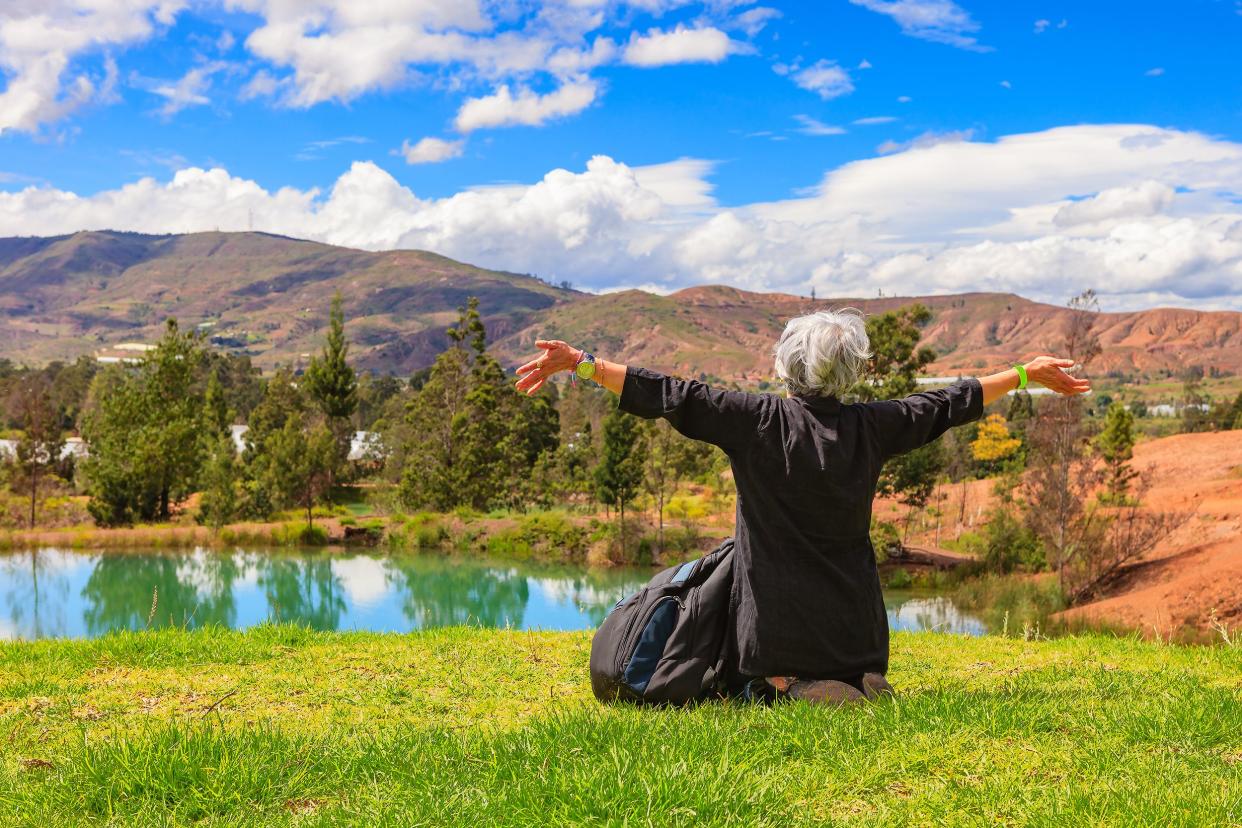 senior woman enjoying the scenery of the the Andes Mountains, Colombia