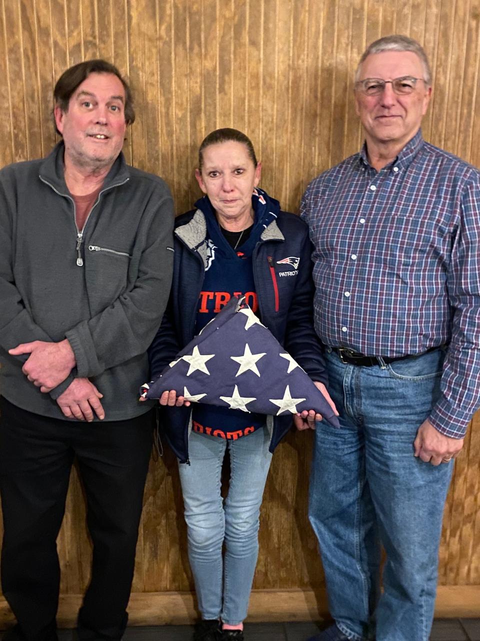 With no blood relatives involved, Lorie Daley received Ken’s funeral honors flag In February 2021 because she was the beneficiary of his insurance policy. Lorie’s husband, John Gallagher, is on the left, while retired Lt. Col. Gerry Larence is at right. Larence worked for more than a year to get Ken’s remains moved to the Veterans Cemetery.