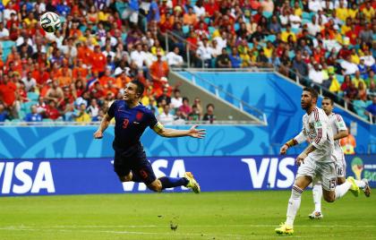 Robin van Persie of the Netherlands (L) heads the ball to score against Spain during their 2014 World Cup soccer match at the Fonte Nova arena in Salvador June 13, 2014. Michael Dalder chose this image as his favourite picture from the World Cup and described the moment as &quot;a spectacular way of scoring a goal, as van Persie dived like Superman!&quot; The decisive moment of the 2014 World Cup is just around the corner, with Germany and Argentina preparing to battle it out in the final on July 13. As they get ready to shoot the big match, Reuters photographers look back at their favourite pictures from the tournament so far. Picture taken July 13, 2014. REUTERS/Michael Dalder (BRAZI - Tags: TPX IMAGES OF THE DAY SOCCER SPORT WORLD CUP)ATTENTION EDITORS PICTURE 12 OF 24 FOR PACKAGE &#39;BRAZIL 2014 - PHOTOGRAPHERS&#39; FAVOURITES&#39; SEARCH &#39;TOPCUP PHOTOGRAPHERS&#39; FAVOURITES&#39; FOR ALL IMAGES