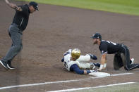 Mississippi State first baseman Luke Hancock (20) looks towards the umpire as he calls Notre Dame's Brooks Coetzee (42) safe after retrieving a passed ball during the NCAA college baseball super regional game, Sunday, June 13, 2021, in Starkville, Miss. (AP Photo/Rogelio V. Solis)