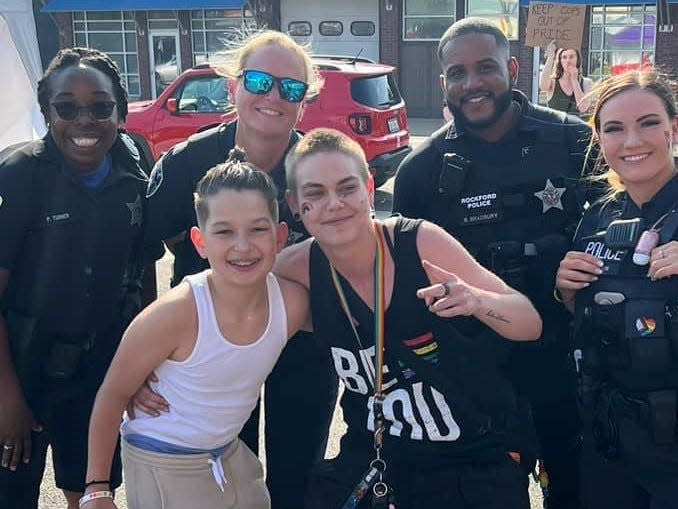 Rockford resident Jordan Donovan, front right, poses with  Weston Davila, 11, and four Rockford Police Department officers at the Rockford Pride Alley Party Saturday, June 3, 2023, in downtown Rockford celebrating Pride month.