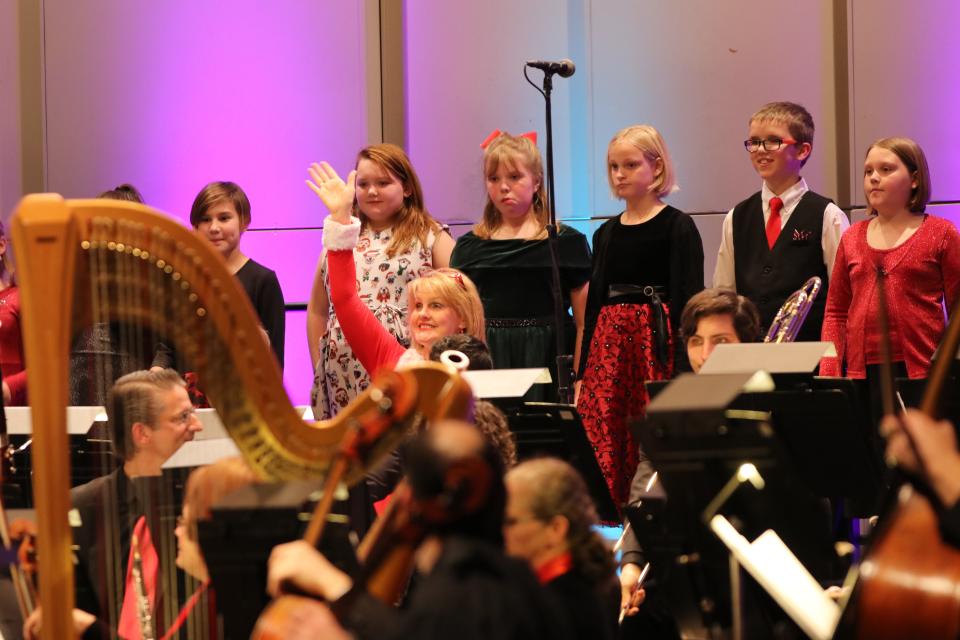 Members of the Clinton Youth Honors Choir, directed by Joyce Collins, are pictured with the Adrian Symphony Orchestra at the ASO's holiday pops concert in 2019.