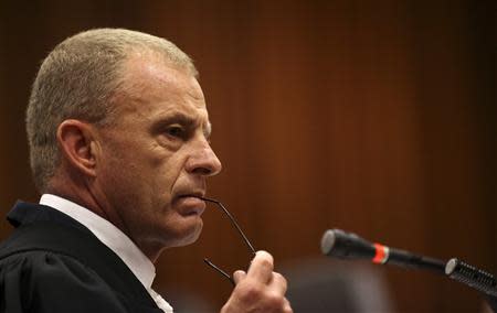 State prosecutor Gerrie Nel looks on as he cross-examines South African Olympic and Paralympic sprinter Oscar Pistorius during his trial at the North Gauteng High Court in Pretoria April 9, 2014. REUTERS/Siphiwe Sibeko