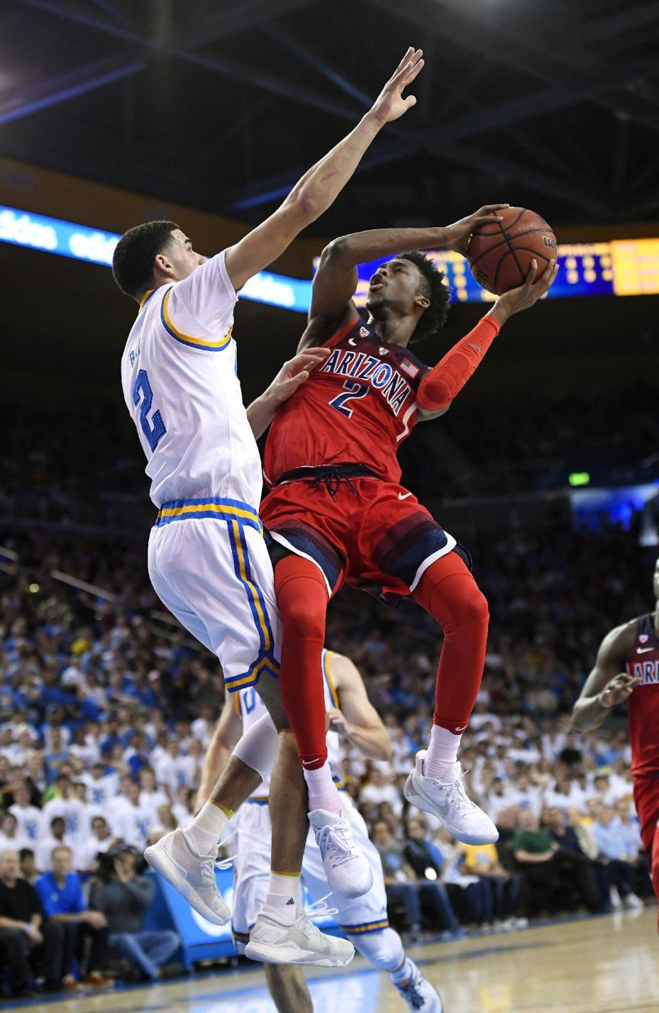 Arizona guard Kobi Simmons, right, shoots as UCLA guard Lonzo Ball defends during the first half of an NCAA college basketball game, Saturday, Jan. 21, 2017, in Los Angeles. (AP Photo/Mark J. Terrill)