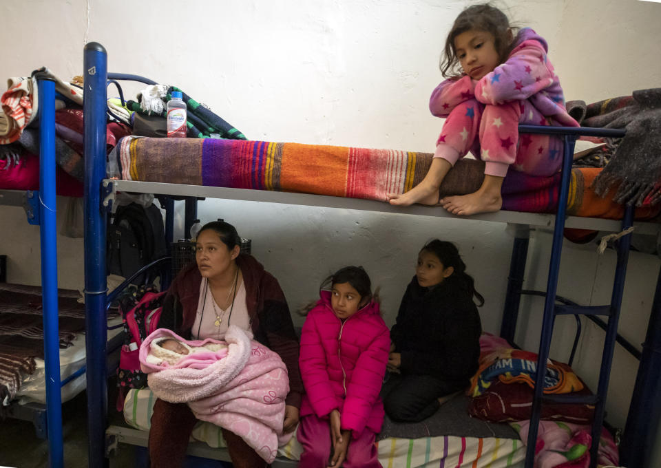 Mexican migrant Carmen Aros and four of her five daughters wait for news before attempting to cross the border into the U.S while staying at a church-run shelter in Ciudad Juarez, Mexico, Sunday, Dec. 18, 2022. Texas border cities were preparing Sunday for a surge of as many as 5,000 new migrants a day across the U.S.-Mexico border as pandemic-era immigration restrictions expire this week, setting in motion plans for providing emergency housing, food and other essentials. (AP Photo/Andres Leighton)
