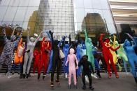 Participants wearing Zentai costumes, or skin-tight bodysuits from head to toe, pose for photos during a march down the shopping district of Orchard Road during Zentai Art Festival in Singapore May 23, 2015. Close to 50 participants strutted down the busy shopping district during the Zentai art festival which is jointly organized by the Japanese embassy. The festival includes performances and discussions on Zentai from May 22 to from June 5. REUTERS/Edgar Su