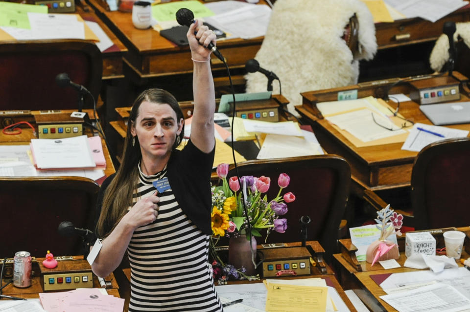 FILE - State Rep. Zooey Zephyr, D-Missoula, alone on the house floor stands in protest as demonstrators are arrested in the house gallery, Monday, April 24, 2023, in the Montana State Capitol in Helena, Mont. The silencing of Zephyr, a transgender lawmaker in Montana, marks the third time in a month that Republicans have attempted to compare disruptive but otherwise peaceful protests at state capitols to insurrections. The tactic follows a pattern set over the past two years when the term has been misused to describe public demonstrations and even the 2020 election that put Democrat Joe Biden in the White House. (Thom Bridge/Independent Record via AP, File)