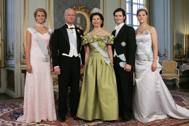 <p>Jonas Ekstromer/AFP via Getty</p> Princess Madeleine, King Carl Gustaf, Queen Silvia, Prince Carl Philip and Crown Princess Victoria of Sweden pose for a family photo in the Royal Palace of Stockholm in 2006.