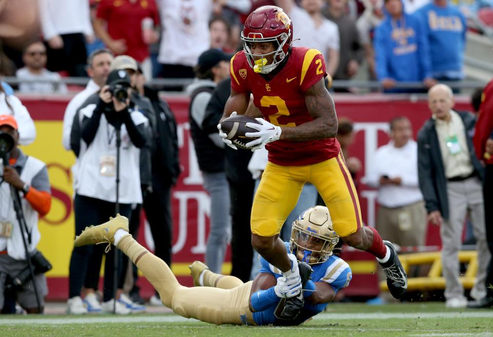 USC Trojans wide receiver Brenden Rice (2) runs after a catch against UCLA Bruins defensive back John Humphrey (6) during the third quarter at United Airlines Field at Los Angeles Memorial Coliseum.