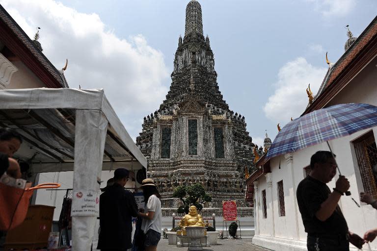 Tourists visit the Temple of Dawn in Bangkok, on March 19, 2014