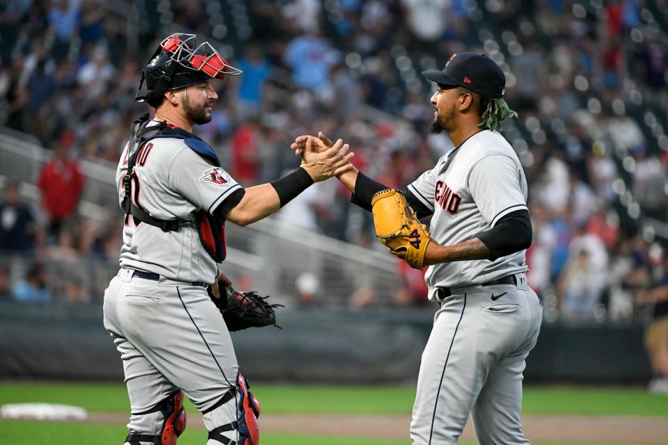 Cleveland Guardians pitcher Emmanuel Clase, right, and catcher Mike Zunino celebrate after defeating the Minnesota Twins in a baseball game, Saturday, June 3, 2023, in Minneapolis.  (AP Photo/Craig Lassig)