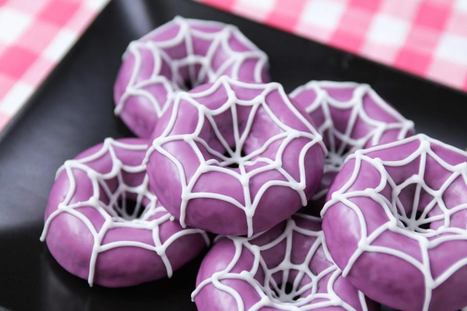 <p>Meet the best vegan baked good for Halloween. A sweet white webbing give the dairy-free blueberry doughnuts a creepy twist!</p><p><strong>Get the recipe:</strong> <a href="https://rosannapansino.com/blogs/recipes/dairy-free-undertale-spider-donuts" rel="nofollow noopener" target="_blank" data-ylk="slk:Undertale Spider Donuts;elm:context_link;itc:0;sec:content-canvas" class="link ">Undertale Spider Donuts</a></p>