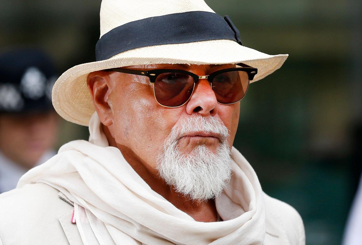 British rocker Gary Glitter leaves Westminster Magistrates' Court in London, Thursday June 19, 2014, where he faces charges in relation to a series of sex offences against two girls in the 1970s and 80s. (AP Photo/Sang Tan)