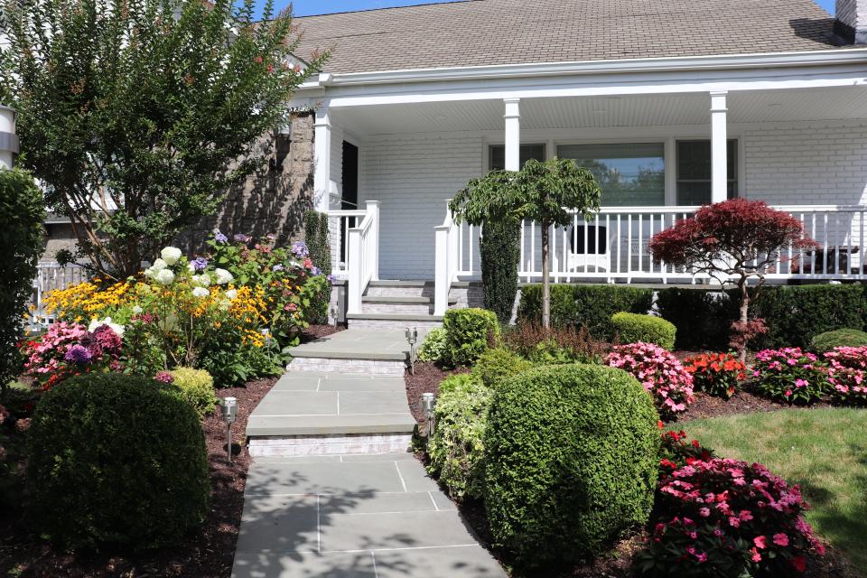 A house in Atlantic Beach with flowers in the yard