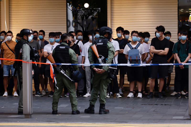 Riot police officers detain people during a protest in Hong Kong