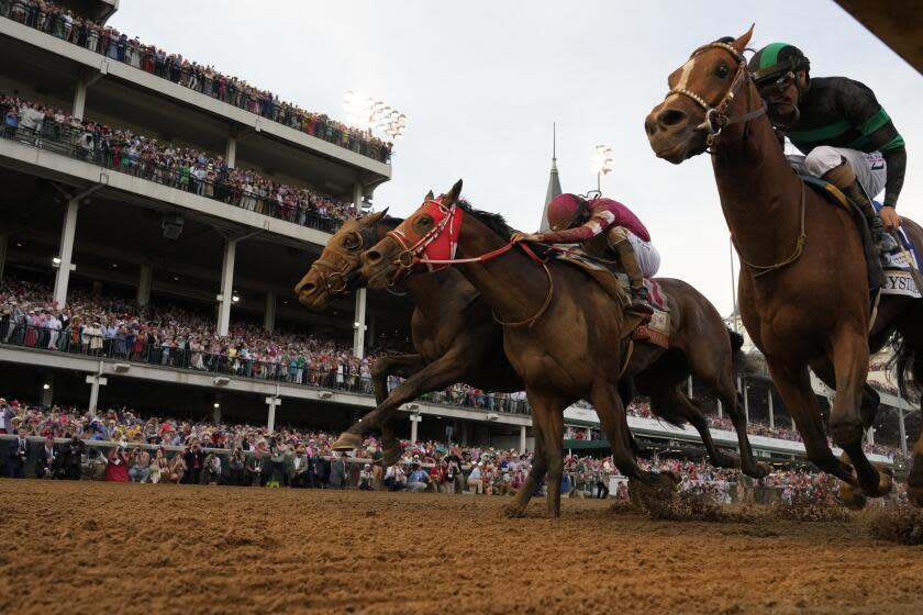 Brian Hernandez Jr. rides Mystik Dan, right, runs to the finish line to win the 150th running of the Kentucky Derby horse race at Churchill Downs Saturday, May 4, 2024, in Louisville, Ky. (AP Photo/Jeff Roberson)