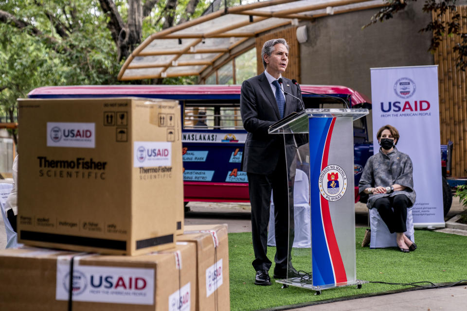 Boxes of medical equipment marked with USAID labels are visible next to Secretary of State Antony Blinken as he speaks at a COVID-19 assistance event outside a COVID-19 vaccination clinic at the Manila Zoo in Manila, Philippines, Saturday, Aug. 6, 2022. Blinken is on a ten-day trip to Cambodia, Philippines, South Africa, Congo, and Rwanda. Also pictured is U.S. Ambassador to the Philippines MaryKay Carlson, right. (AP Photo/Andrew Harnik, Pool)
