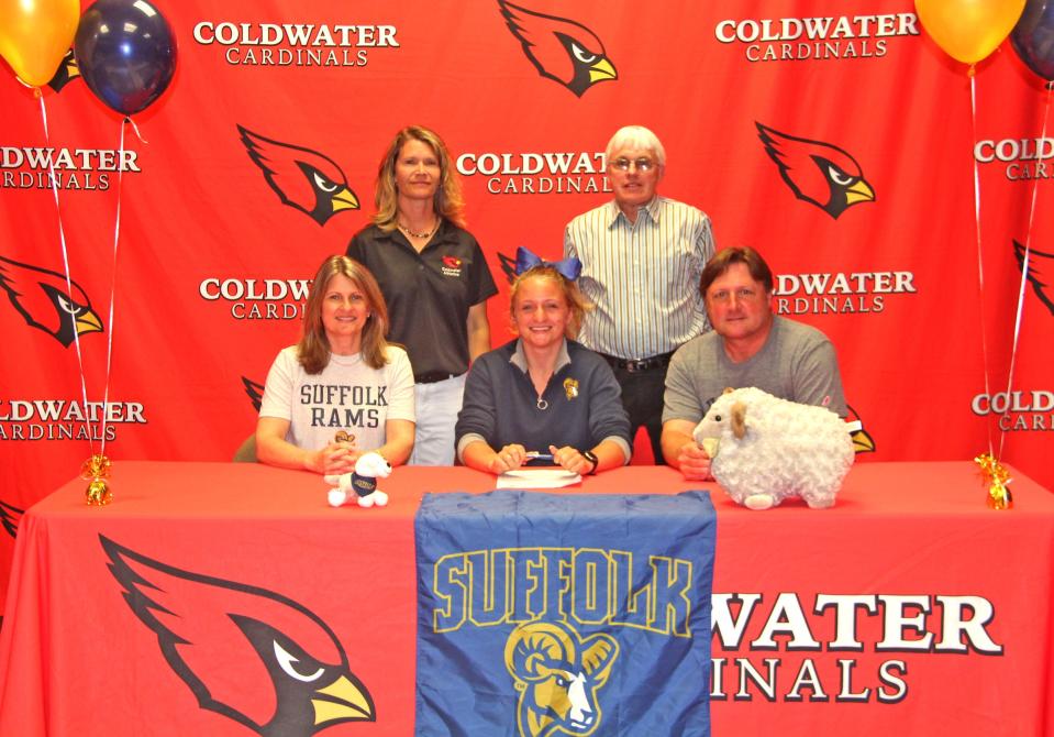 Coldwater's Sarah Forrister (center), surrounded by her parents and coaches  Danielle Kelly and Jim Bilsborrow, signed her letter of intent to run track for Suffolk University