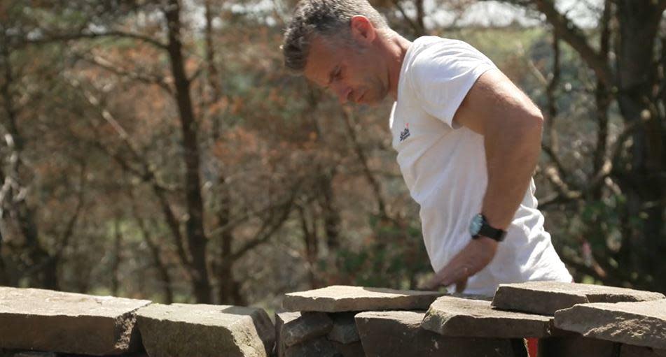 British Army Veteran Mikey Allen works on his castle in the Welsh mountains. / Credit: CBS News