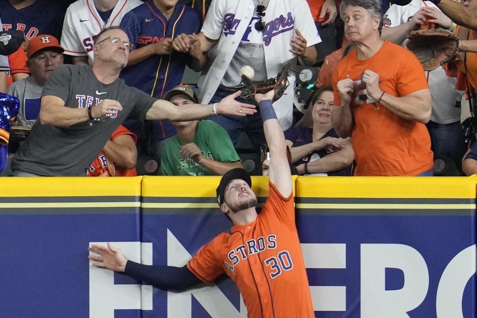 Houston Astros' Kyle Tucker can't catch a two run home run hit by Texas Rangers' Jonah Heim during the fourth inning of Game 6 of the baseball AL Championship Series Sunday, Oct. 22, 2023, in Houston. (AP Photo/Godofredo A. Vásquez)