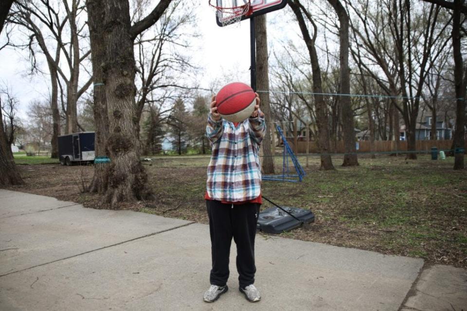 Joey plays basketball in his driveway in this file photo from Makenzie Huber of South Dakota Searchlight. He is one South Dakota child impacted by the state’s gender-affirming care ban, which has been implemented in several surrounding states.