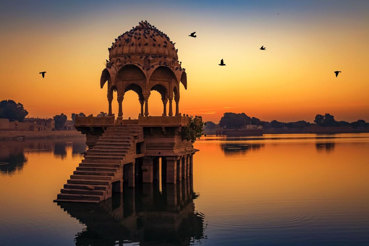 gadisar lake at jaisalmer rajasthan at sunrise with ancient temples and archaeological ruins