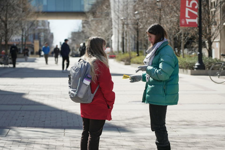 Dahlia Saba, a student activist, passes out flyers on campus (Lilly Umana / NBC News)