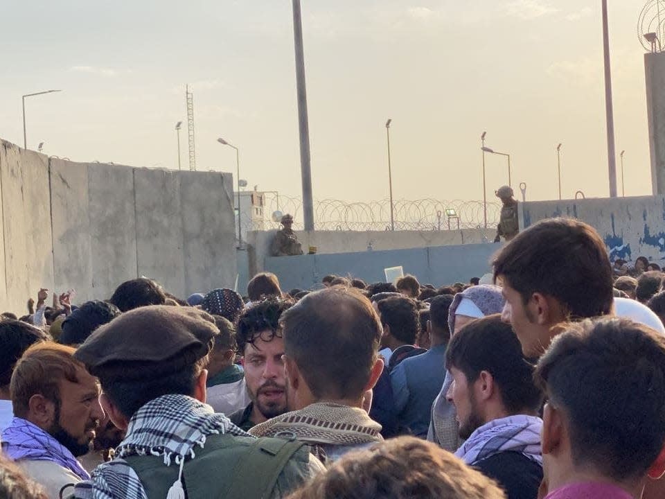 people outside kabul airport crowd