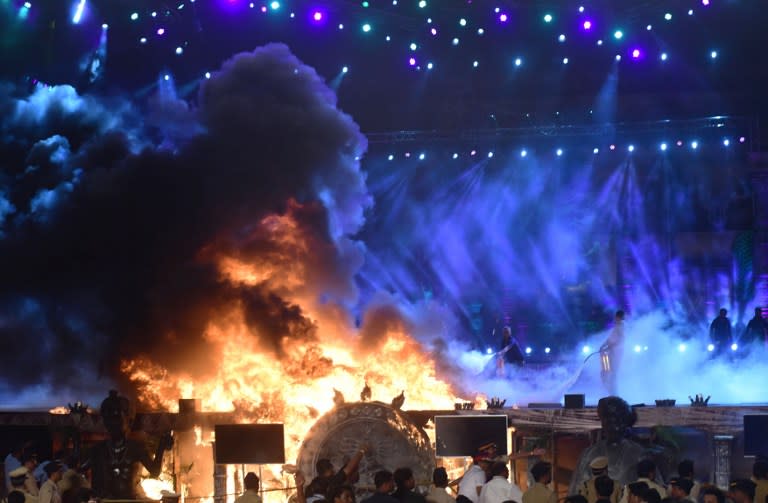 <p>Participants leave an arena after a fire broke out during an event held as part of the ‘Make in India Week’ in Mumbai on February 14, 2016. A huge fire gutted a stage hosting a cultural event in Mumbai that was part of the Indian government’s much-trailed ‘Make in India’ week on February 14. AFP PHOTO / STR / AFP PHOTO / STR </p>