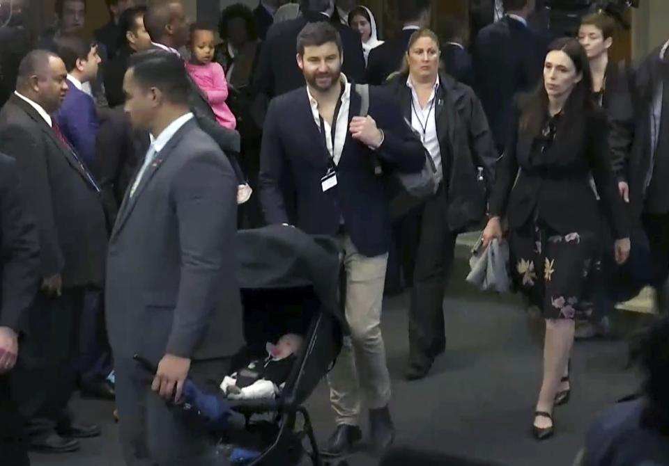 FILE - In this Sept. 25, 2018, file frame from video, New Zealand Prime Minister Jacinda Ardern, right, and her partner, Clarke Gayford, pushing a baby carriage with their child Neve, exits the 73rd session of the United Nations General Assembly, at U.N. headquarters. It's not unheard of for politicians to sometimes bring their children to work. Providence, R.I., Mayor Jorge Elorza occasionally brings his son Omar to events, as does Washington, D.C., Mayor Muriel Bowser with her daughter, Miranda. (AP Photo/File)