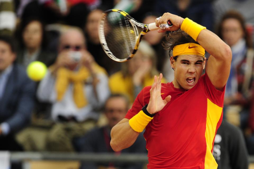 Spain's Rafael Nadal returns a ball to Argentina's Juan Monaco during the Davis Cup final first match at La Cartuja Olympic stadium in Sevilla on December 2, 2011. Nadal won 6-1, 6-1, 6-2.   AFP PHOTO / JAVIER SORIANO (Photo credit should read JAVIER SORIANO/AFP/Getty Images)