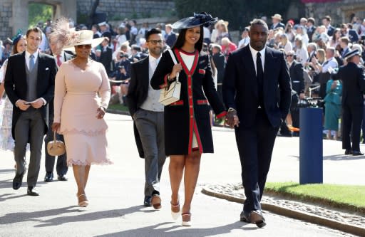 US talk show host Oprah Winfrey (second left) and British actor Idris Elba (right) arrive for the wedding of Britain's Prince Harry and US actress Meghan Markle at St George's Chapel, Windsor Castle