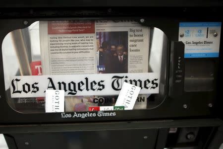 A newspaper vending box is seen outside the building of Los Angeles Times newspaper, which is owned by Tribune Publishing Co, in Los Angeles, California, U.S., April 27, 2016. REUTERS/Lucy Nicholson/Files