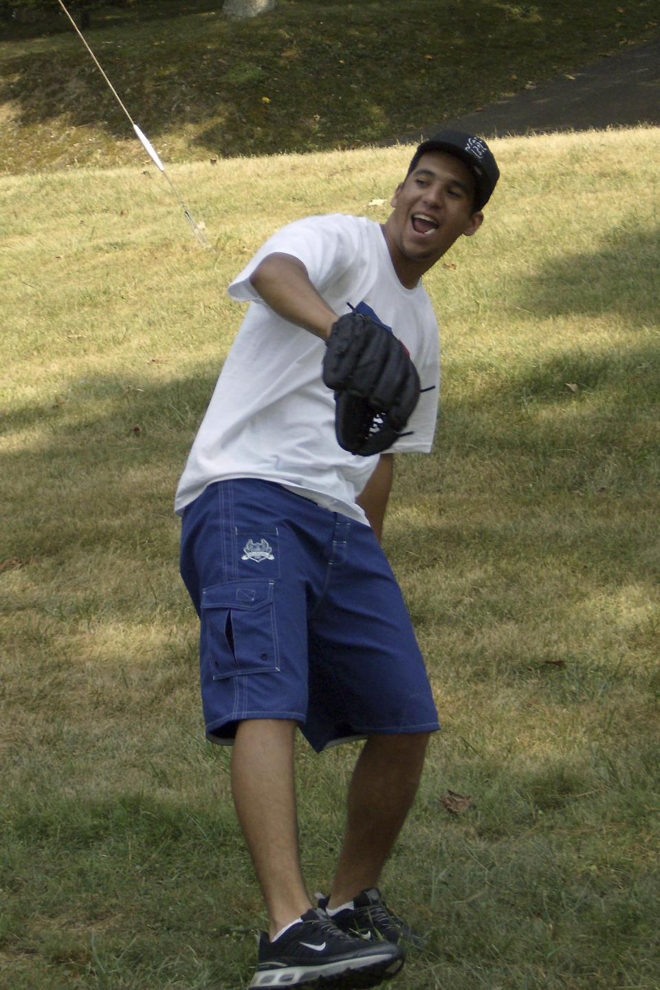 In this photo provided by TeriAnn Reynolds, minor league baseball player David Peralta, of Venezuela, plays outside his host family residence in Johnson City, Tenn., in August 2007. Host family programs were suspended during the coronavirus pandemic over health concerns. Now, they may never return. (Photo courtesy TeriAnn Reynolds via AP)