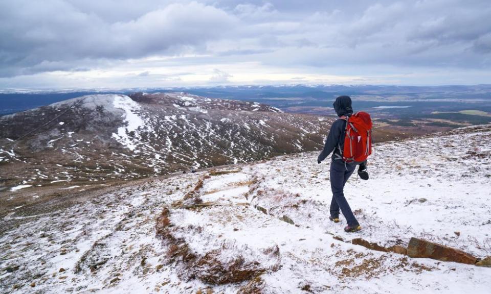 A hiker descending Meall a Bhuachaille Cairn in the Cairngorms in the Scottish Highlands, UK.FKM3WC A hiker descending Meall a Bhuachaille Cairn in the Cairngorms in the Scottish Highlands, UK.